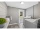 Laundry room with washer and dryer, tiled flooring, neutral walls, and door to the backyard at 4925 Camellia S Way, St Petersburg, FL 33705