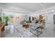 Bright, open-concept living room with modern furniture, sleek flooring, and access to outdoor spaces at 4925 Camellia S Way, St Petersburg, FL 33705