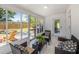 Enclosed sun room featuring tile flooring, glass windows, wicker furniture and access to backyard at 4925 Camellia S Way, St Petersburg, FL 33705