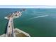 Beautiful aerial shot of the bridge crossing the sea and boats gliding through clear blue water at 5 Island Park Pl # 305, Dunedin, FL 34698