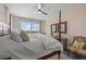 Comfortable bedroom features a ceiling fan and a sliding glass door to the balcony at 5 Island Park Pl # 305, Dunedin, FL 34698