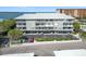 Exterior view of a condo with four floors, multiple balconies, and covered parking at 5 Island Park Pl # 305, Dunedin, FL 34698