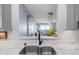 Beautiful kitchen features stainless steel sink, sleek marble countertops, and modern fixtures at 5 Island Park Pl # 305, Dunedin, FL 34698