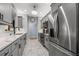 Updated kitchen with modern grey cabinets, stainless appliances, and marble countertops and flooring at 5 Island Park Pl # 305, Dunedin, FL 34698