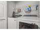 Functional laundry room with modern Samsung washer and dryer and wire shelving for storage at 5 Island Park Pl # 305, Dunedin, FL 34698