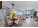 Bright and airy living area with a glass-topped dining table offers access to the water view at 5 Island Park Pl # 305, Dunedin, FL 34698