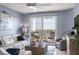 Comfortable living room with access to a balcony showcases the water view at 5 Island Park Pl # 305, Dunedin, FL 34698
