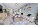Open-concept living room features ample seating and views to the dining area at 5 Island Park Pl # 305, Dunedin, FL 34698