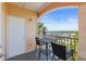 Balcony with black table and chairs overlooking the water, with an arched entryway for sun protection at 5000 Culbreath Key Way # 8-308, Tampa, FL 33611