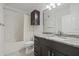 Bathroom featuring a dark vanity with a marble countertop, a wall cabinet, and a tub and shower at 5000 Culbreath Key Way # 8-308, Tampa, FL 33611