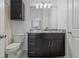 Bathroom featuring a dark vanity with a marble countertop, a wall cabinet, and a tub and shower with a shower curtain at 5000 Culbreath Key Way # 8-308, Tampa, FL 33611