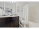 Bathroom with a vanity that has a dark wood base, marble countertop, a large mirror, and a shower with a tub at 5000 Culbreath Key Way # 8-308, Tampa, FL 33611