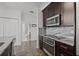 Efficient kitchen design with stainless steel appliances, granite counters, and a streamlined layout at 5000 Culbreath Key Way # 8-308, Tampa, FL 33611