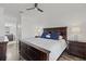 Comfortable primary bedroom with dark wood furniture, white bedding, and ensuite bathroom access at 5000 Culbreath Key Way # 8-308, Tampa, FL 33611