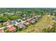 Aerial view of a home with a screened in pool, lush landscaping, and golf course views at 5137 Epping Ln, Zephyrhills, FL 33541