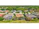 Aerial view of neighborhood featuring a house with a screened pool surrounded by other homes and trees at 5137 Epping Ln, Zephyrhills, FL 33541