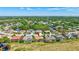 A high angle aerial view shows a home in a neighborhood near a body of water and green surroundings at 5137 Epping Ln, Zephyrhills, FL 33541
