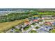 A high angle aerial view showcases a home with screened in pool in a lush neighborhood near a golf course at 5137 Epping Ln, Zephyrhills, FL 33541