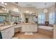 Large bathroom featuring double sinks, soaking tub, and a chandelier at 5137 Epping Ln, Zephyrhills, FL 33541