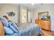 Bedroom featuring a view of the ensuite bathroom, a dresser, and hardwood floors at 5137 Epping Ln, Zephyrhills, FL 33541