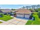 Charming single-story home with a well-manicured lawn, vibrant landscaping, and a spacious two-car garage at 5137 Epping Ln, Zephyrhills, FL 33541