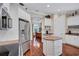Modern kitchen with stainless steel appliances, an island, and a built-in desk area at 5137 Epping Ln, Zephyrhills, FL 33541