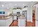 Well-appointed kitchen with white cabinetry, stainless steel appliances, and a center island at 5137 Epping Ln, Zephyrhills, FL 33541