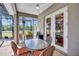 Cozy screened lanai features dining area with view of the landscaped backyard and access to the pool at 5137 Epping Ln, Zephyrhills, FL 33541