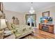 Main bedroom featuring a decorative chandelier, TV, and hardwood floors at 5137 Epping Ln, Zephyrhills, FL 33541