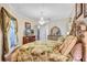 Spacious main bedroom featuring an elegant chandelier, TV, and decorative accents at 5137 Epping Ln, Zephyrhills, FL 33541