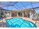 The sparkling screened-in pool is surrounded by brick pavers and comfortable outdoor seating at 5137 Epping Ln, Zephyrhills, FL 33541