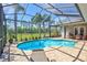 Inviting screened pool with lush landscaping and open view in the backyard with lounging chairs at 5137 Epping Ln, Zephyrhills, FL 33541