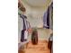 Spacious walk-in closet featuring custom shelving and rod system for organized storage and laminated floor at 5137 Epping Ln, Zephyrhills, FL 33541
