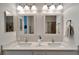 Bathroom featuring dual sinks, vanity, framed mirrors, and great lighting at 527 Manns Harbor Dr, Apollo Beach, FL 33572
