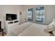 Inviting bedroom with a large TV, dresser, and sunny windows offering a bright and airy ambiance at 527 Manns Harbor Dr, Apollo Beach, FL 33572
