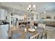 Open concept dining area with stylish chandelier, flowing into a modern kitchen and comfortable living space at 527 Manns Harbor Dr, Apollo Beach, FL 33572