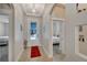 Inviting foyer with decorative lighting, neutral tones, and access to bedrooms and main living areas at 527 Manns Harbor Dr, Apollo Beach, FL 33572