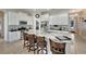 Open kitchen design featuring a large island with seating, stainless appliances, and white cabinets at 527 Manns Harbor Dr, Apollo Beach, FL 33572