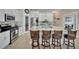 Well-equipped kitchen boasting granite countertops, a large island, and stainless steel appliances at 527 Manns Harbor Dr, Apollo Beach, FL 33572