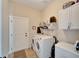 Functional laundry room equipped with a washer, dryer, storage cabinets, and ample space at 527 Manns Harbor Dr, Apollo Beach, FL 33572