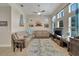 Open concept living room with bright window light, cozy sectional couch, and tall ceilings at 527 Manns Harbor Dr, Apollo Beach, FL 33572