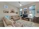 Bright living room with high ceilings, large windows, and comfortable seating arrangement at 527 Manns Harbor Dr, Apollo Beach, FL 33572