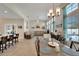 Open-concept living area featuring a dining area, a comfortable lounge, and ample natural light at 527 Manns Harbor Dr, Apollo Beach, FL 33572