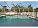 Screened pool with clear water, lounge chairs, and lush landscaping for relaxing outdoors at 527 Manns Harbor Dr, Apollo Beach, FL 33572