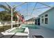 Sparkling pool and spa area under a screened enclosure, surrounded by well-manicured landscaping at 527 Manns Harbor Dr, Apollo Beach, FL 33572