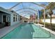 Stunning screened-in pool with flags, offering a perfect outdoor oasis at 527 Manns Harbor Dr, Apollo Beach, FL 33572