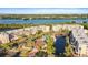 Aerial view of the community's condos, clubhouse, and pool overlooking the lake, lush greenery, and serene waterfront at 6495 Shoreline Dr # 8106, St Petersburg, FL 33708