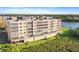 Aerial view of condominium building close to the lake, lush landscaping, and serene waterfront setting at 6495 Shoreline Dr # 8106, St Petersburg, FL 33708
