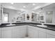 Bathroom with double vanity, white cabinets, and granite countertops at 6495 Shoreline Dr # 8106, St Petersburg, FL 33708