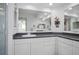 Bathroom with double vanity, white cabinets, and granite countertops at 6495 Shoreline Dr # 8106, St Petersburg, FL 33708